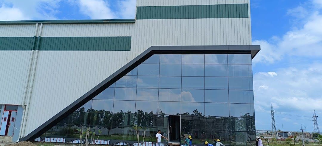 Angled glass curtain wall at the Mahindra Swaraj plant, Ambala